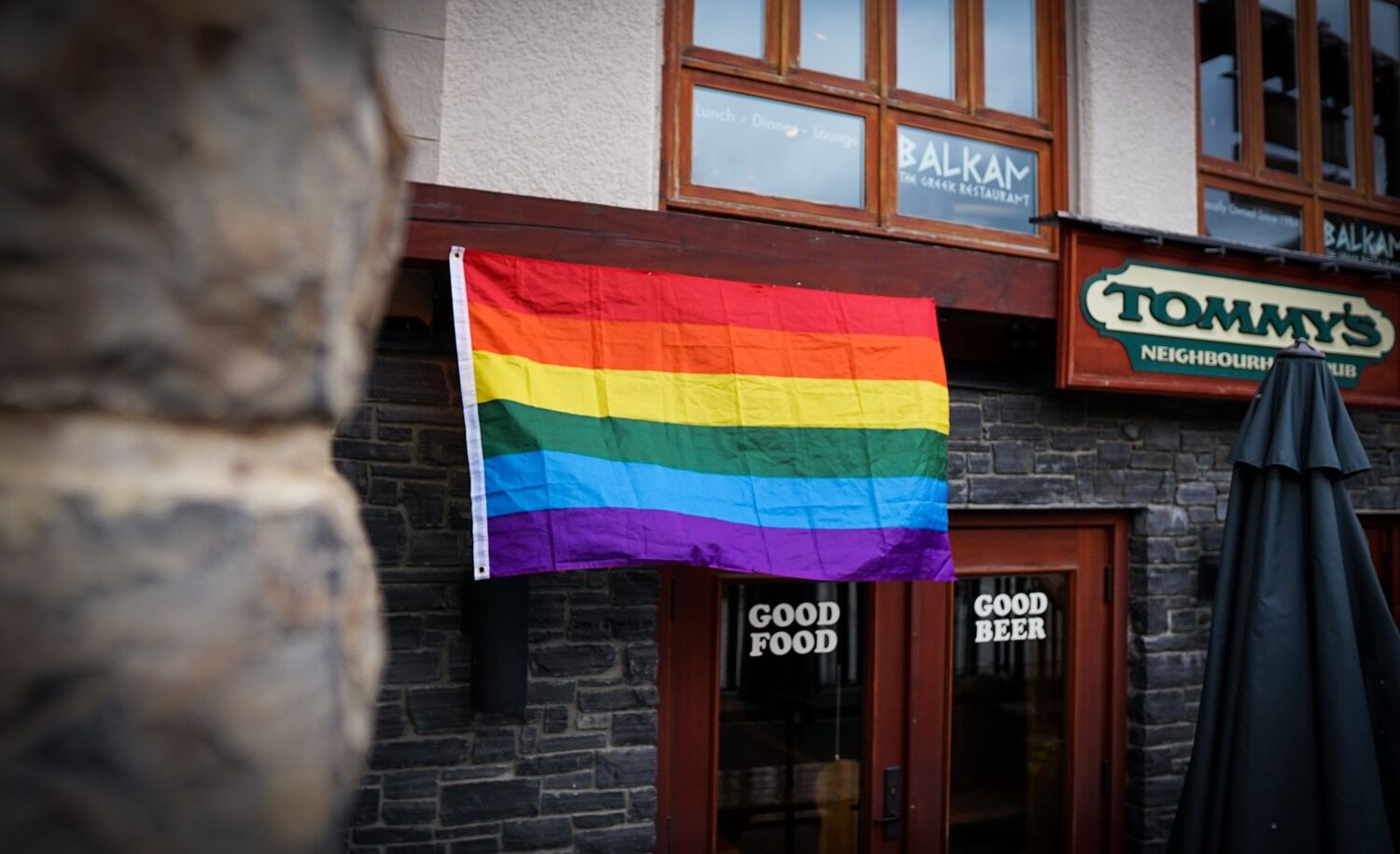 Banff Pride flag in front of Tommy's Neighborhood Pub.